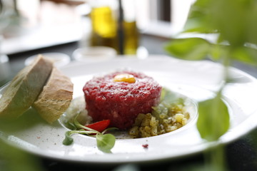 Beef tartare with egg and pickles. Appetizing appetizer. Suggestion to serve the dish. Culinary photography.