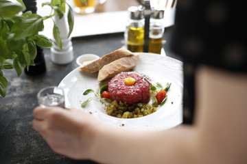 Beef tartare with egg and pickles. Appetizing appetizer. Suggestion to serve the dish. Culinary photography.