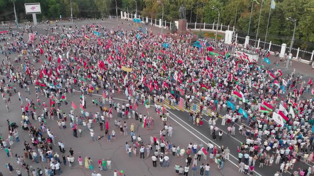Gomel, Belarus - 08/18/2020: Rally in support of President Lukashenko in the square. Large flag of belarus. Crowd, many flags, top view. Elections of the President of Belarus.