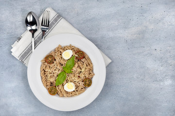 Vegetarian Vegetable pasta Fusilli in white bowl.