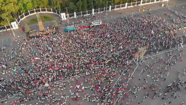 Gomel, Belarus - 08/18/2020: Crowd of people waving flags and balloons at rally in support of President Lukashenko. Large flag of belarus. Flying over the crowd. Elections of the President of Belarus