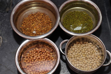 Fresh green gram beans and peanuts with channa dal on black background