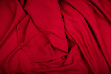 Dramatic closeup folds of dark red or wine red drapery (with copyspace for text)