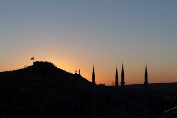 View of Nevsehir Castle at sunset with Turkish flag in Kayasehir