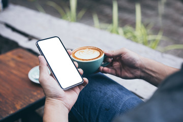 cell phone mockup image blank white screen.man hand holding texting using mobile on desk at coffee shop.background empty space for advertise.work people contact marketing business,technology