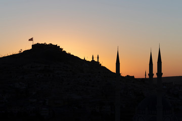 View of Nevsehir Castle at sunset with Turkish flag in Kayasehir