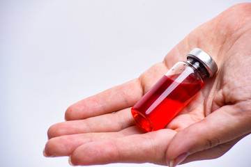 Woman hand with medical ampoule vial for infection. Corona virus infection, COVID-19, nCoV-2019 vaccine. Glass bottle with hand isolated on white background. 