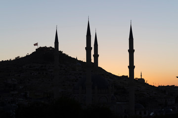View of Nevsehir Castle at sunset with Turkish flag in Kayasehir