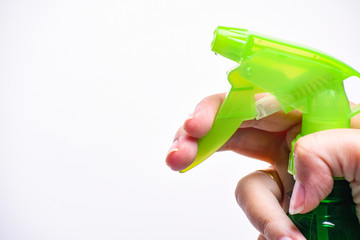 Hand holding plastic spray bottle - hold plastic spray bottle isolated on white. Man with water...