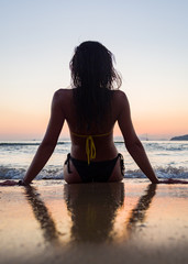 Fototapeta na wymiar Woman in swiming suit posing on the beach