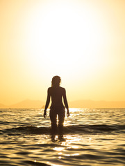 Woman in swiming suit posing on the beach