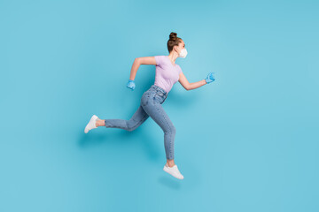 Full body profile photo of pretty lady use respirator jumping high up running fast rush shopping center sale season opening wear t-shirt jeans shoes gloves isolated blue color background