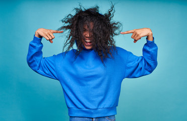 Funny dark-skinned curly woman with a naughty hairstyle.