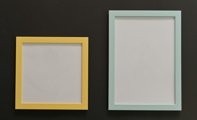 Close-up of Green and yellow mock-up frames with white background on black background,Top view shot.