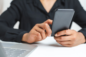 modern phone been hold by an afro american woman. Selective focus on device