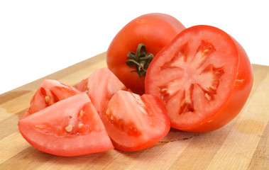 Tomato vegetables pile isolated on wooden board