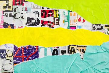 Torn and crumpled blue, yellow and green pieces of paper on colorful collage from clippings with letters and numbers texture background. Space for text.