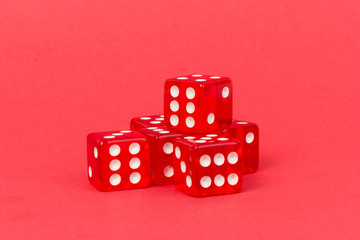 Transparent and red glass dices isolated on red background.