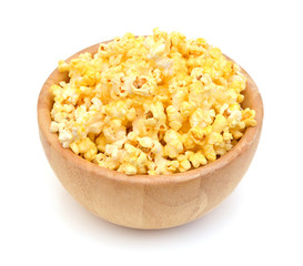 fresh popped popcorn isolated in wooden bowl on white background