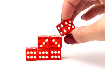 Transparent and red glass dices in hand isolated on white background.