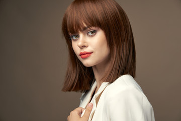 Beautiful model in light coat gesticulate with hands 