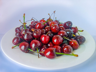 Red sweet berries on a plate. Vegetarian food for health. Selective focus