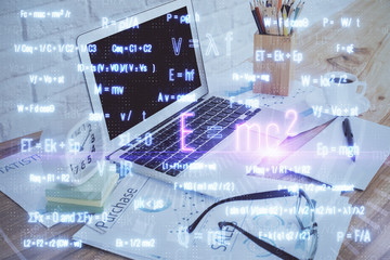 Desktop computer background and formula hologram writing. Double exposure. Education concept.
