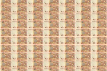 2 Ukrainian hryvnias bills printed in money production conveyor. Collage of many bills. Concept of...