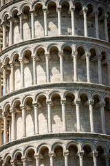 Fototapeta na wymiar Closeup of Leaning Tower of Pisa, bell tower of the Cathedral (Duomo di Santa Maria Assunta) in Romanesque style. (1173 - XIV Century). Tuscany, Italy, Europe