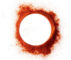 Red paprika, pepper powder pile, round frame and border isolated on black background, top view