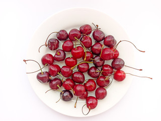  Cherries on a white background. Berries on a white plate. Selective focus
