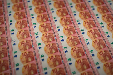 10 euro bills printed in illegal money production conveyor. Collage of many fake bills. Concept of...