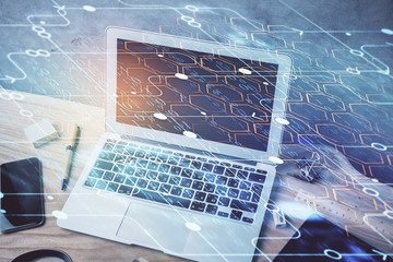 Double exposure of desktop computer and technology theme hologram. Concept of software development.