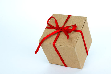Gift box with red ribbon isolated on white. The concept of gifts for the holidays. Christmas and New Year. Cardboard box decorated with a red ribbon.