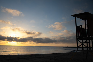 A lifeguard tower during sunrise