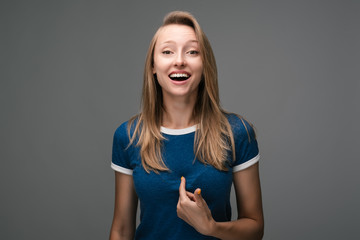 Woman points at herself with forefinger. Human emotions, facial expression concept.