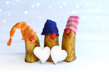 two hearts and a trio of merry gnomes in hats. celebrating winter holidays together