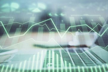 Forex market chart hologram and personal computer background. Double exposure. Concept of investment.
