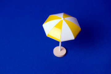 multicolored beach umbrella on blue background