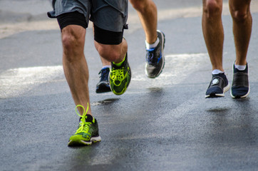 Fototapeta na wymiar men running in marathon city shoe laces road runner