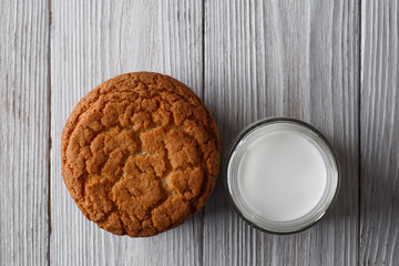 Tasty cookies and a glass of milk in a transparent glass on a white background