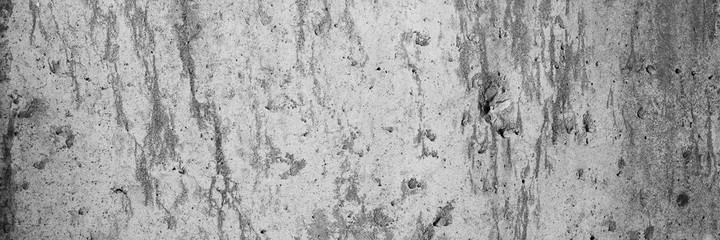 Texture of old cracked concrete wall. Rough gray concrete surface. Wide panoramic background for design.