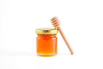 honey and honey in jar on white background