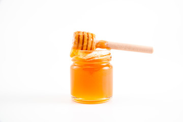 honey and honey in jar on white background