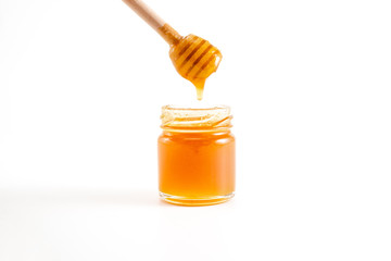 honey and honey in jar on white background