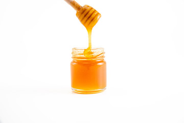 honey and honey in jar on white background