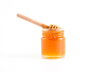 honey and honey in jar on white background