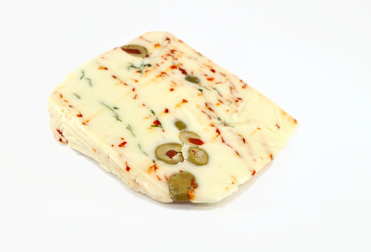 Slice of Pecoricco, a Sicilian sheep-goat cheese
stuffed with rocket, capers, olives and red chilli on white background
