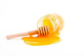 honey and honey in jar on white background