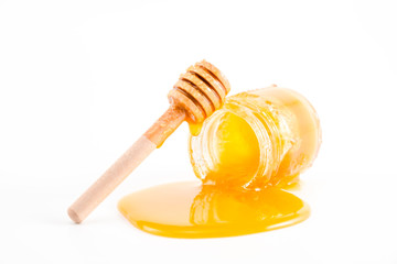 honey and honey in jar on white background